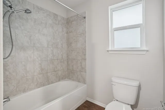 a white bath tub sitting next to a toilet