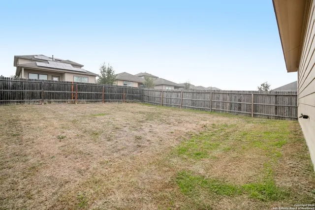 a view of outdoor space and backyard