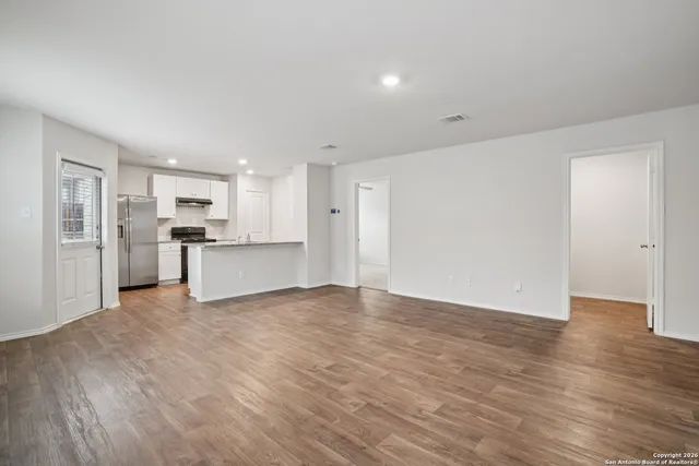 a view of a kitchen with a sink and a refrigerator