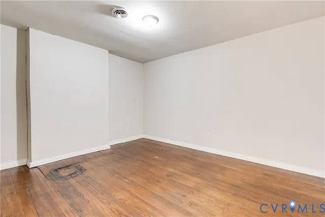 an empty room with wooden floor