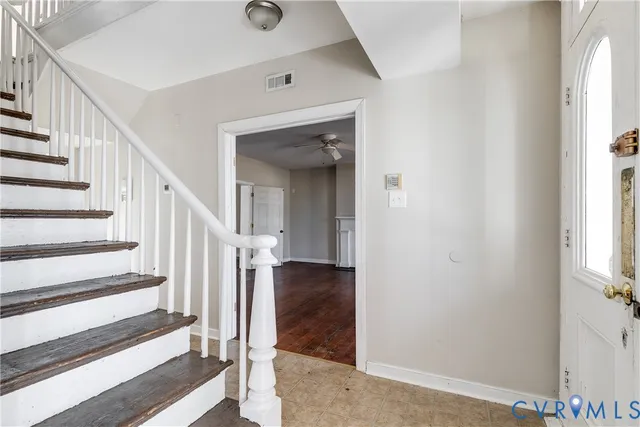 a view of a hallway with wooden floor and entryway