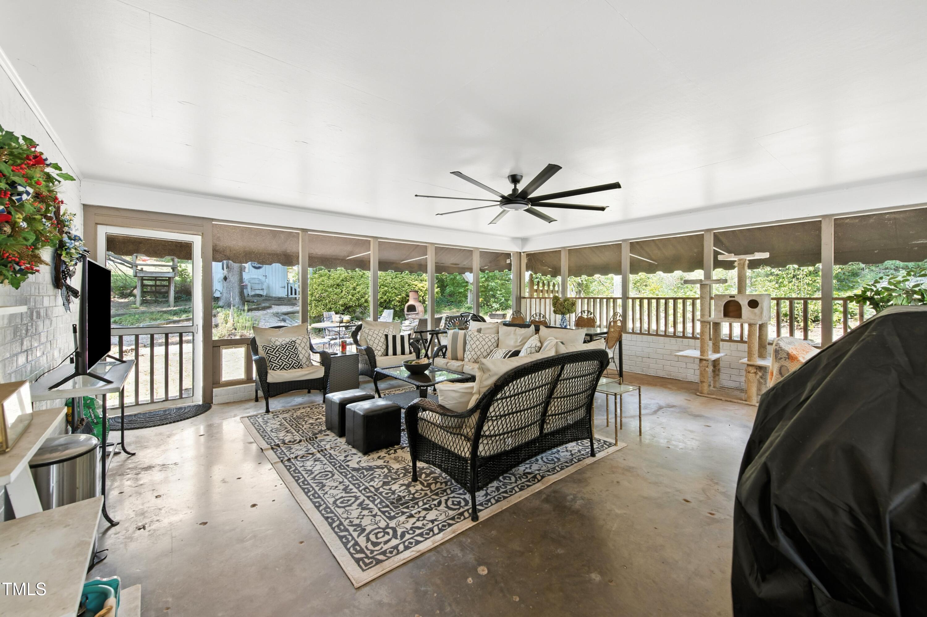 222 Gardiner Road Asheboro, NC 27203 - Photo 12 of 32 a living room with furniture ceiling fan and a floor to ceiling window