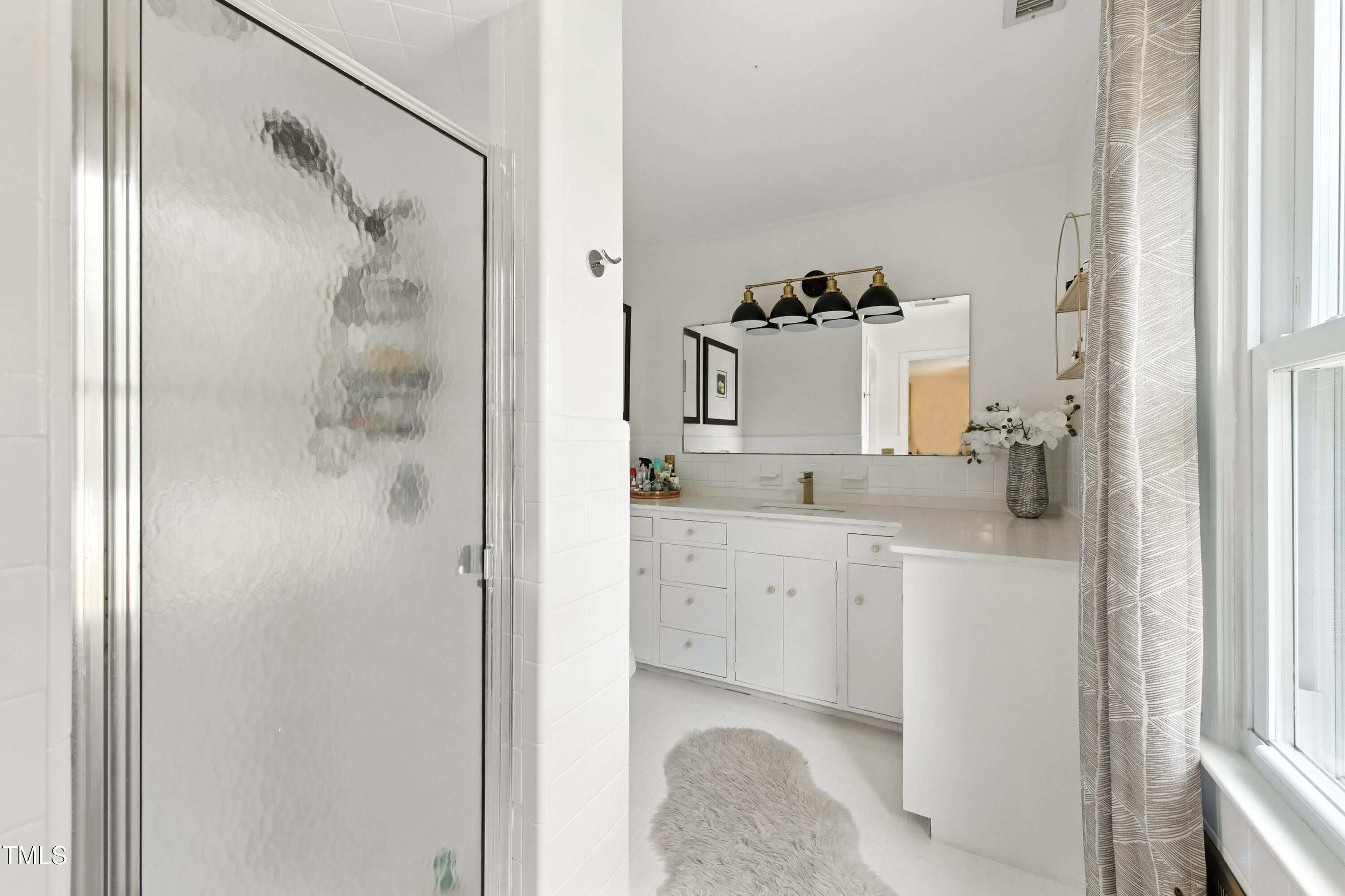 222 Gardiner Road Asheboro, NC 27203 - Photo 15 of 32 a bathroom with a sink double vanity and shower
