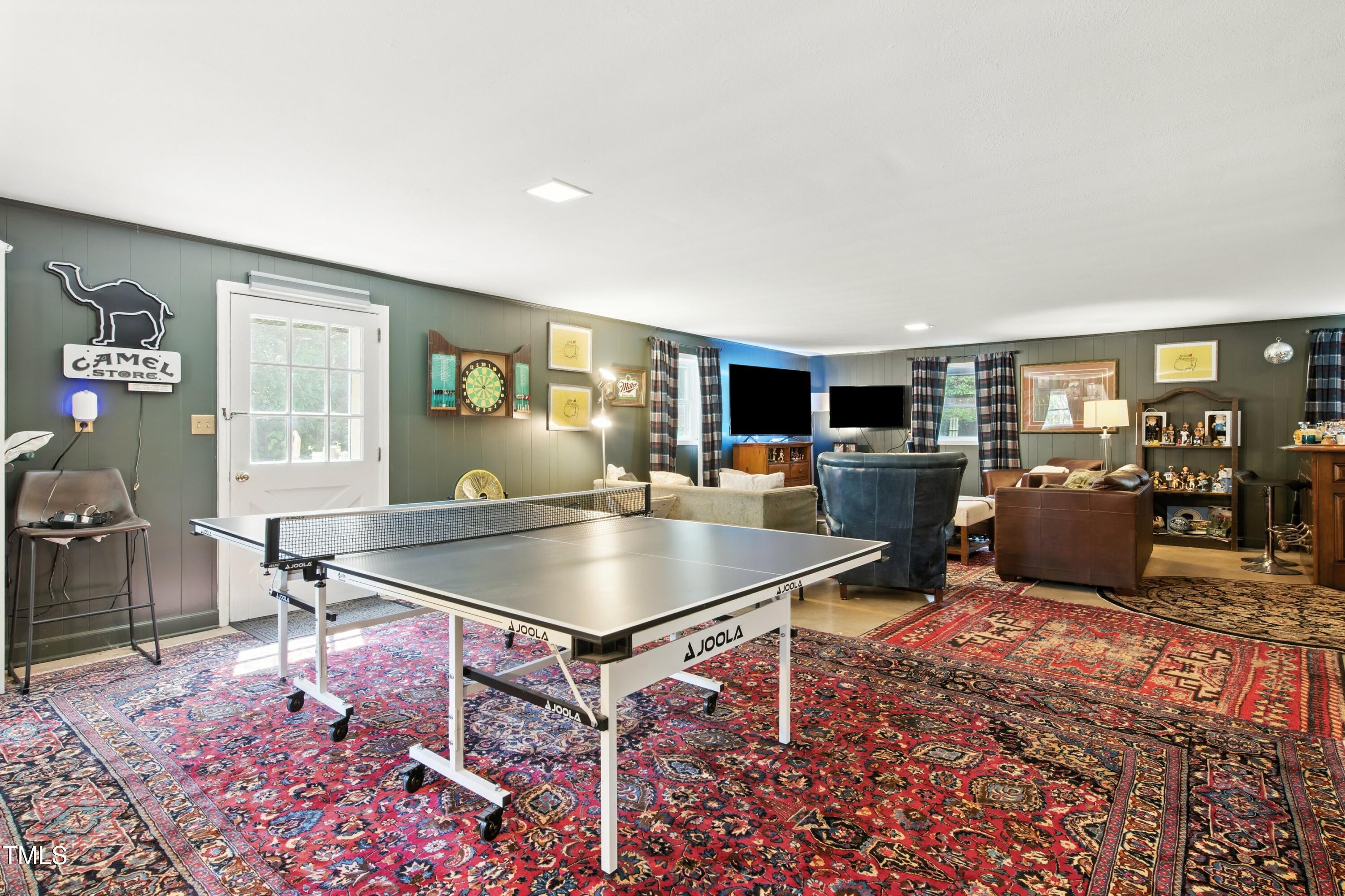 222 Gardiner Road Asheboro, NC 27203 - Photo 22 of 32 a living room with furniture a flat screen tv and a table
