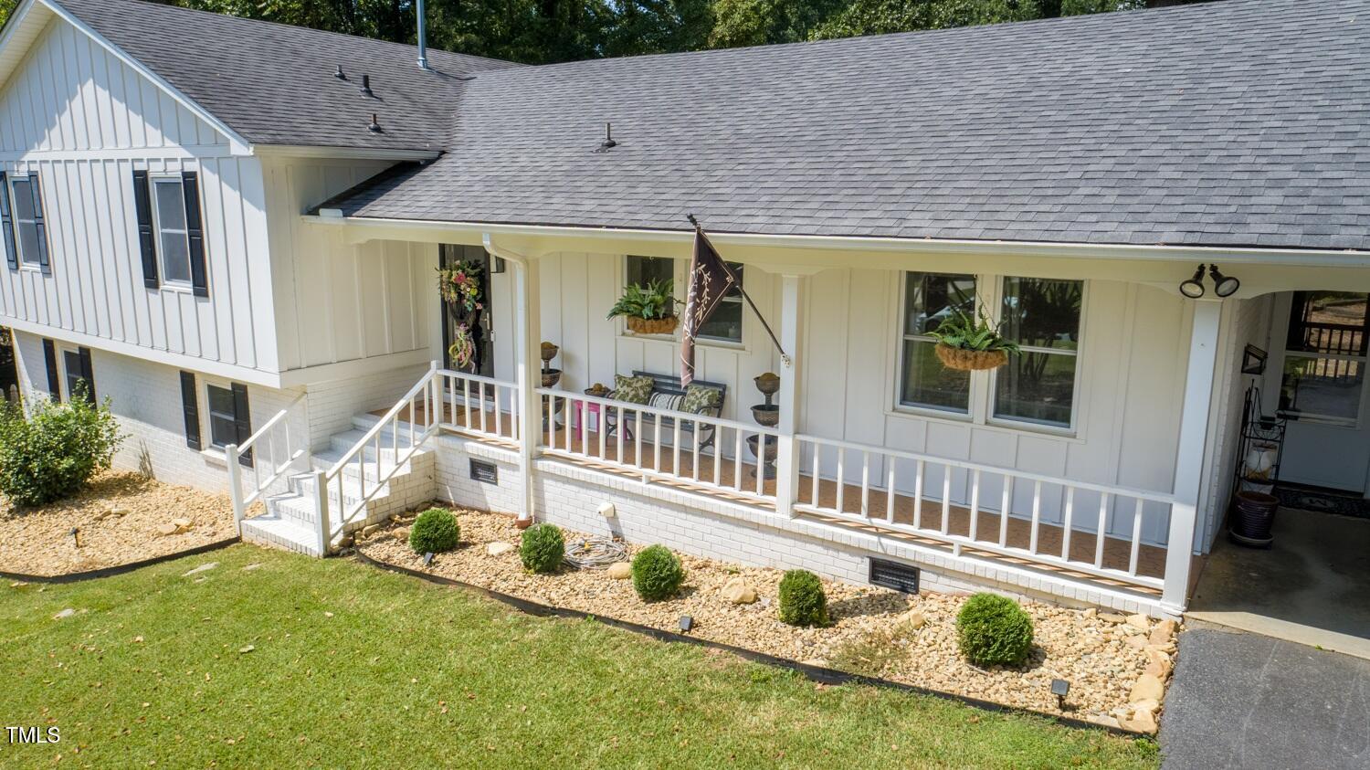 222 Gardiner Road Asheboro, NC 27203 - Photo 29 of 32 a front view of a house with wooden deck and furniture
