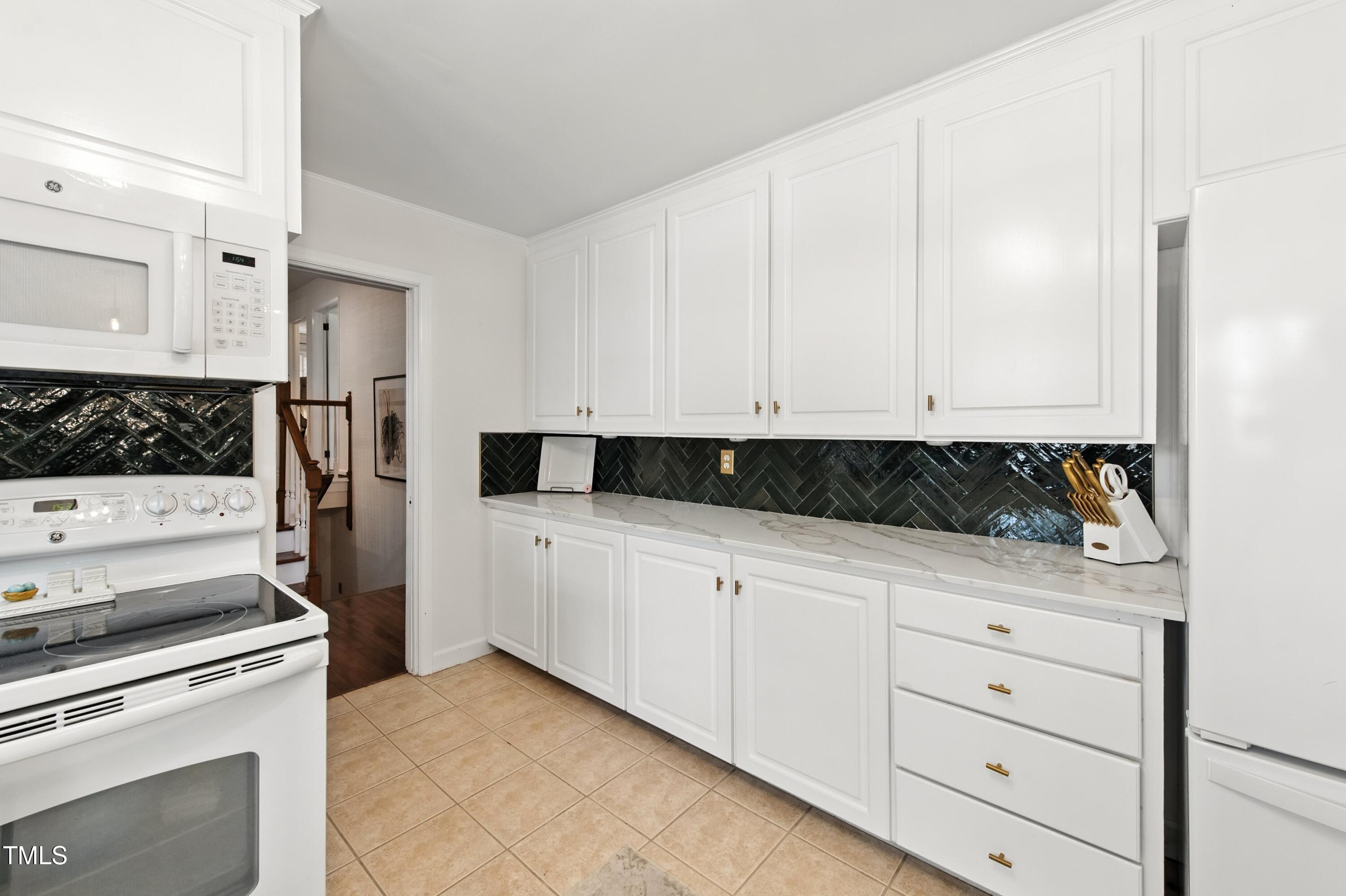 222 Gardiner Road Asheboro, NC 27203 - Photo 7 of 32 a kitchen with white cabinets and white appliances