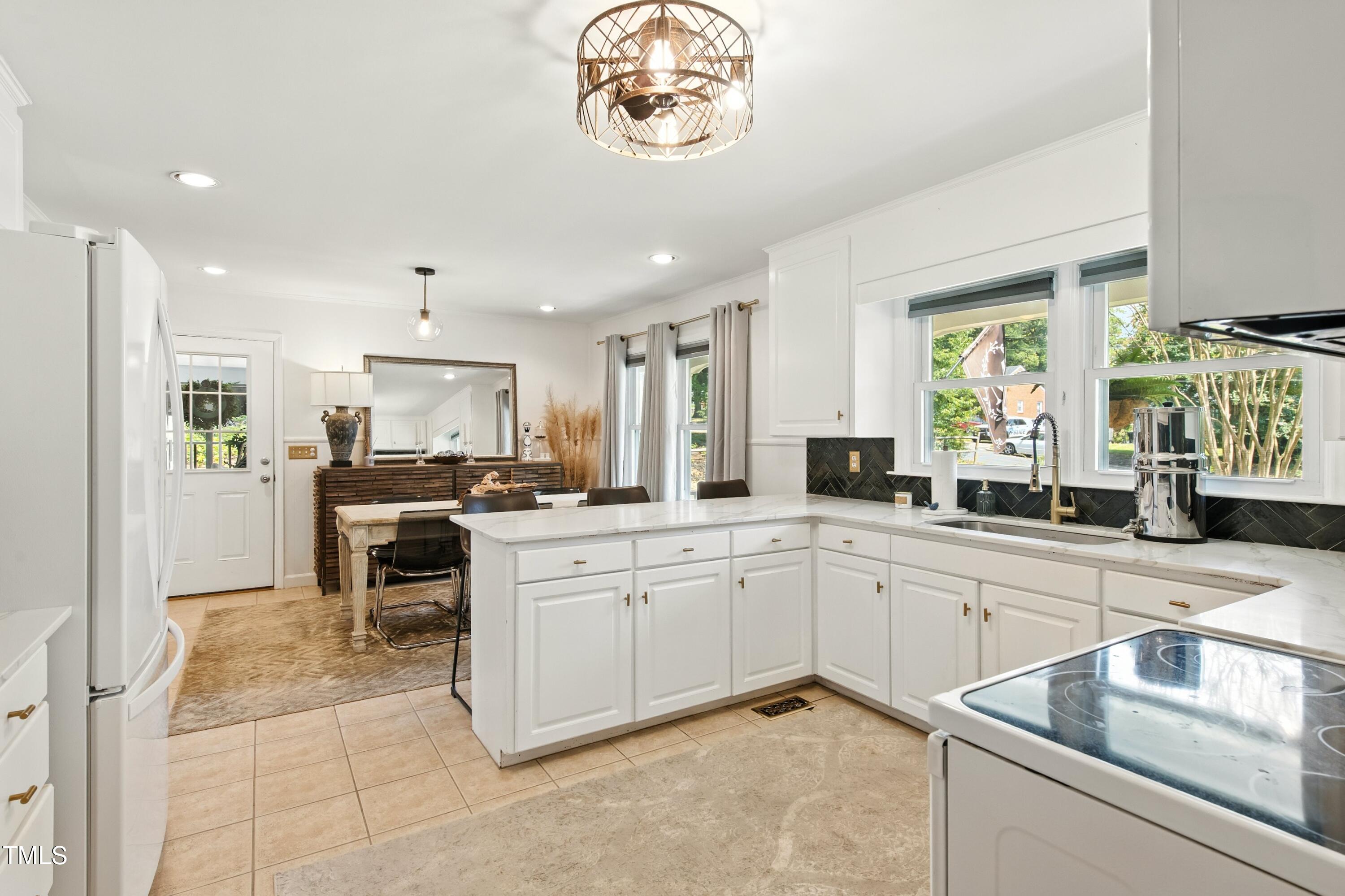 222 Gardiner Road Asheboro, NC 27203 - Photo 8 of 32 a kitchen with a sink cabinets and window