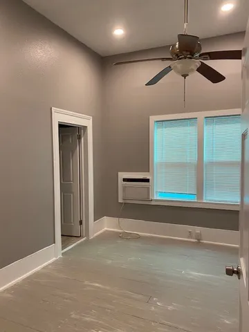 a view of a livingroom with a ceiling fan and window