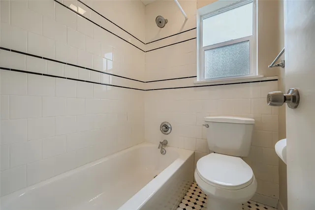 a bathroom with a toilet and a bathtub