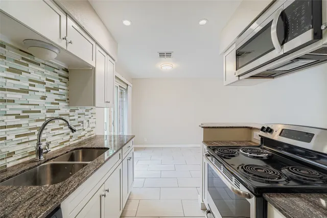 a kitchen with a stove and a sink
