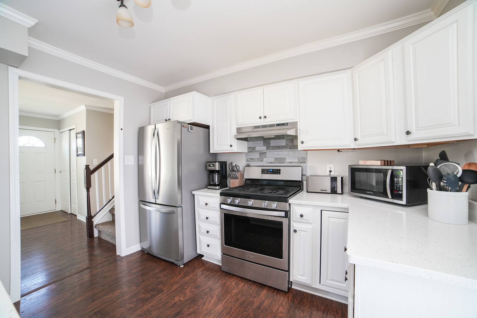 281 Kathy Drive Bourbonnais, IL 60914 - Photo 15 of 43 a kitchen with cabinets stainless steel appliances and wooden floor