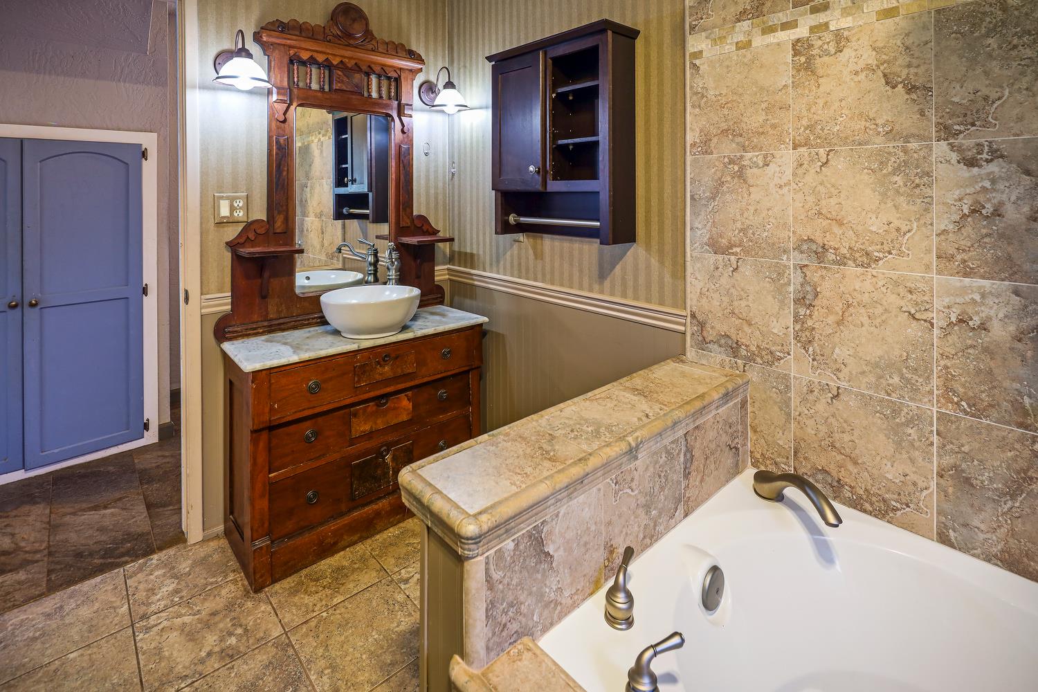 6612 Michel Road Mountain Ranch, CA 95246 - Photo 26 of 78 a bathroom with a bathtub sink and mirror