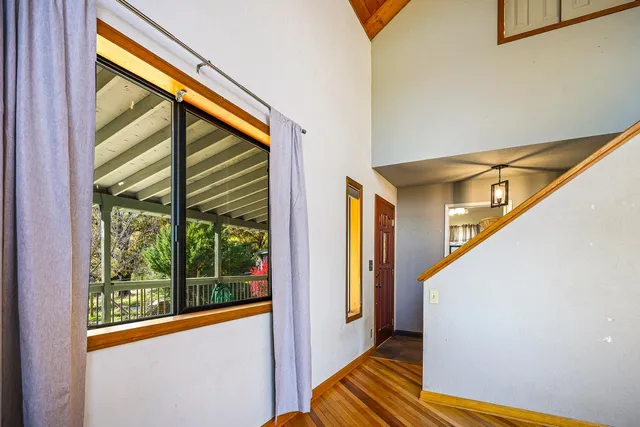 a living room with large windows and a flat screen tv