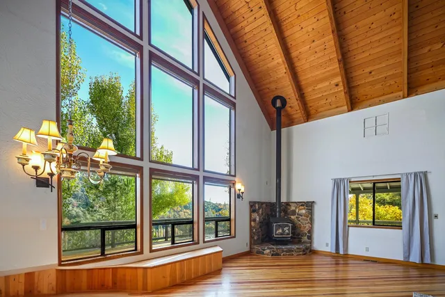 a living room with a fireplace furniture and a large window