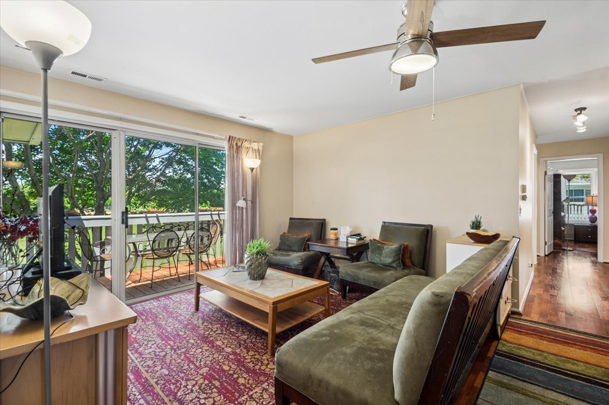 166 Hemingway Court, Unit 252 Vernon Hills, IL 60061 - Photo 5 of 18 a living room with furniture a table and a floor to ceiling window