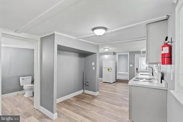 a very nice looking room with wooden floor and a bathroom