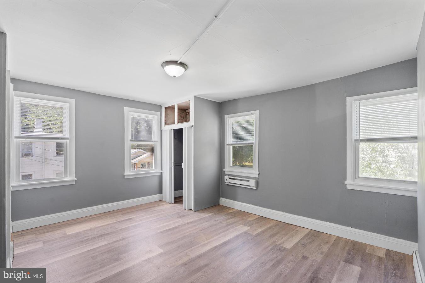 210 Church Street Salem, NJ 08079 - Photo 14 of 35 a view of an empty room with wooden floor and a window