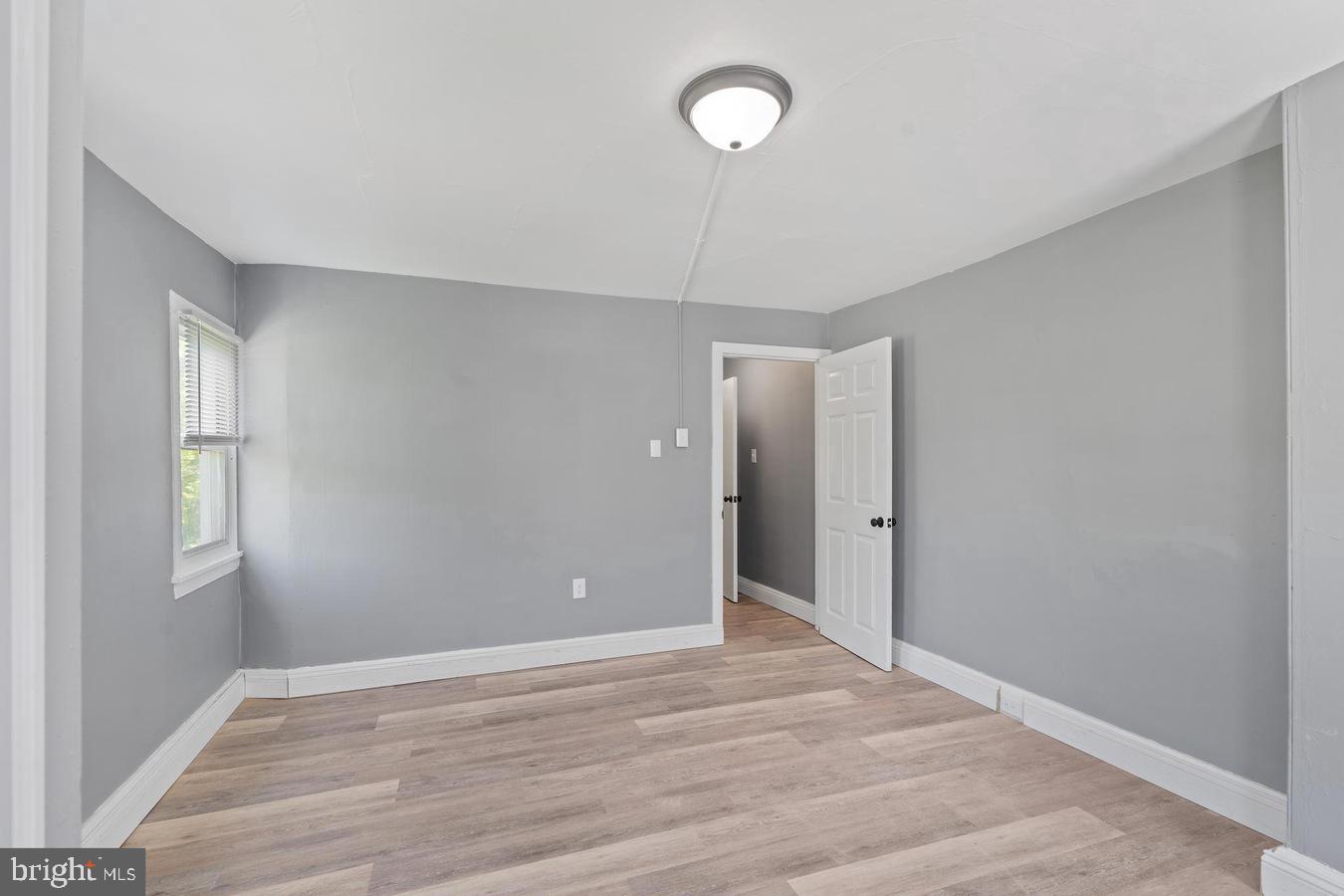 210 Church Street Salem, NJ 08079 - Photo 16 of 35 a view of an empty room with window and wooden floor