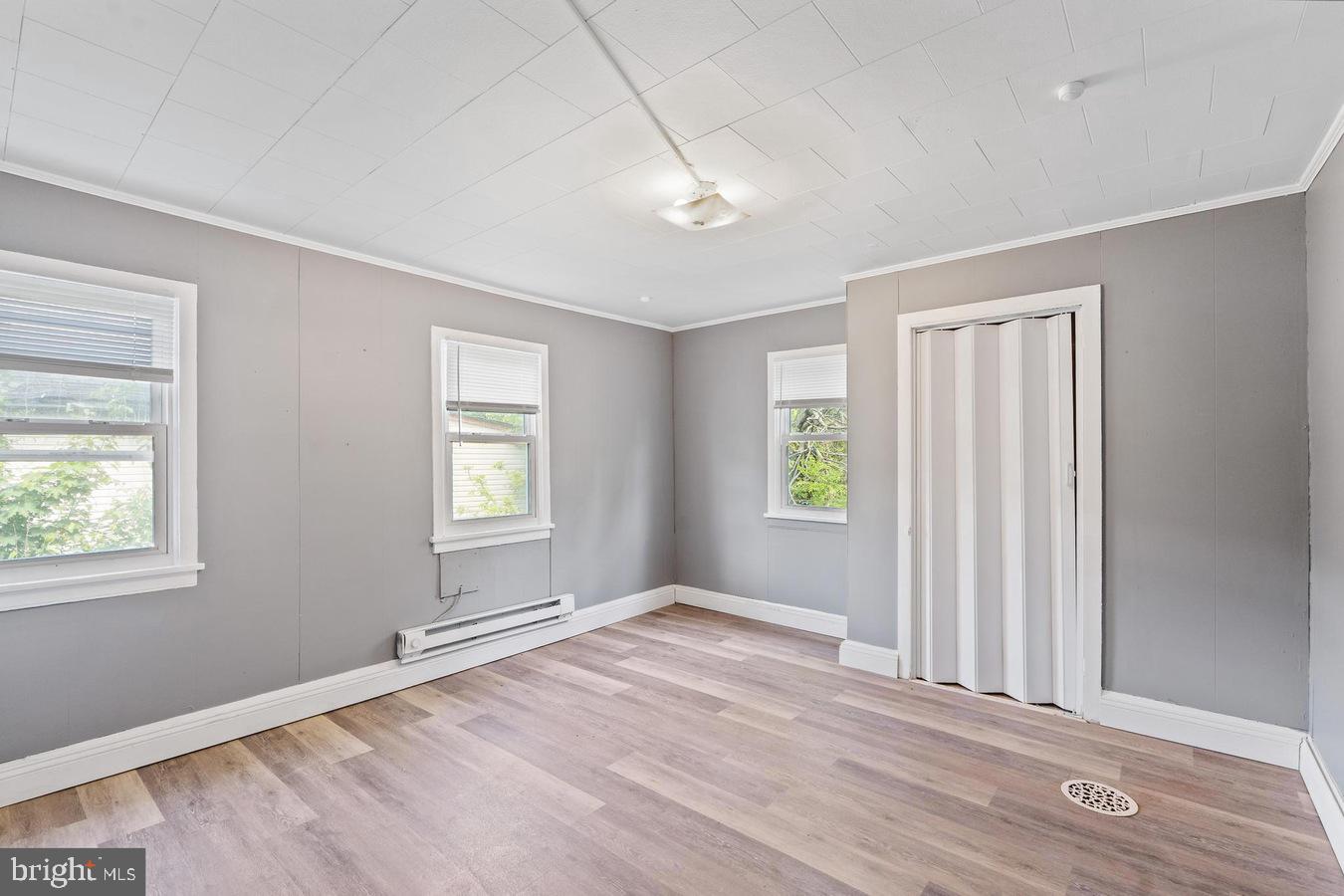 210 Church Street Salem, NJ 08079 - Photo 17 of 35 a view of empty room with wooden floor and fan
