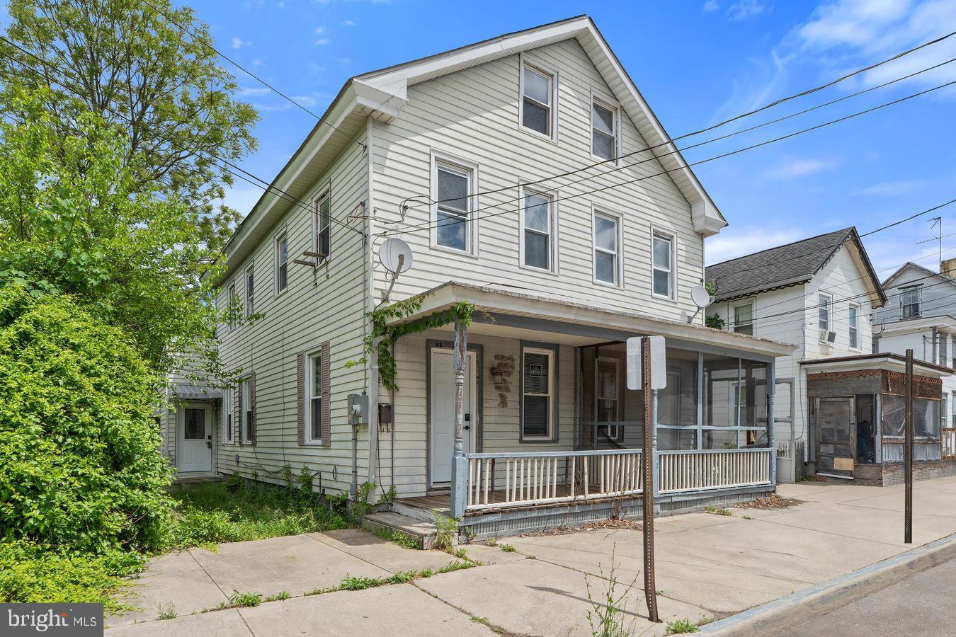 210 Church Street Salem, NJ 08079 - Photo 2 of 35 a front view of a house with a garden