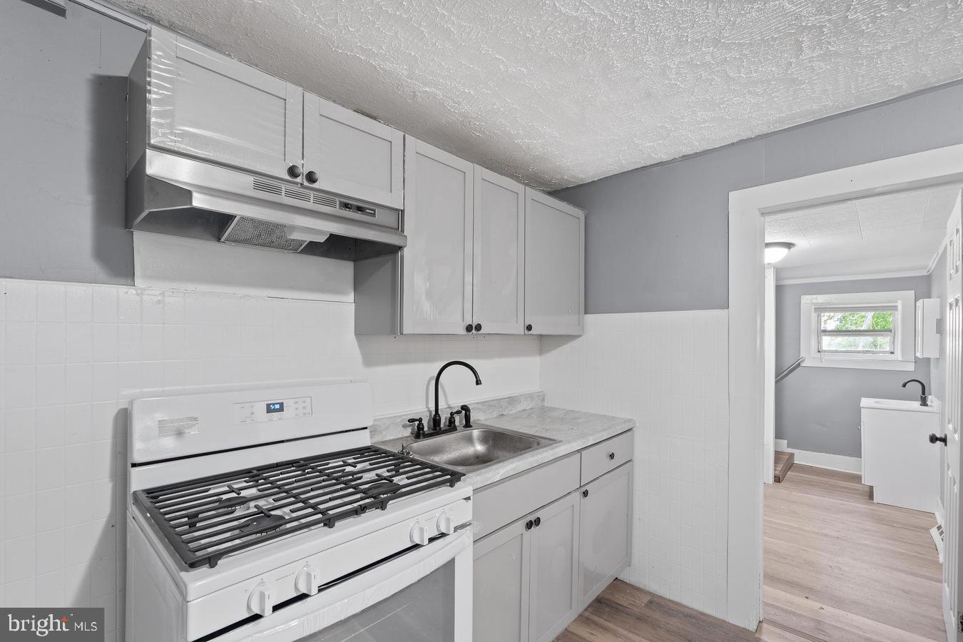 210 Church Street Salem, NJ 08079 - Photo 28 of 35 a kitchen with cabinets appliances and wooden floor