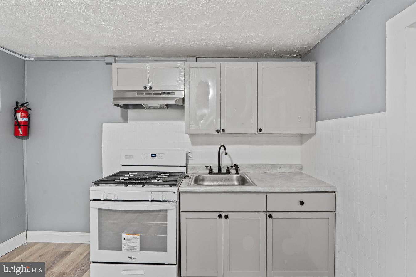 210 Church Street Salem, NJ 08079 - Photo 29 of 35 a kitchen with stainless steel appliances granite countertop a stove a sink and a white cabinets