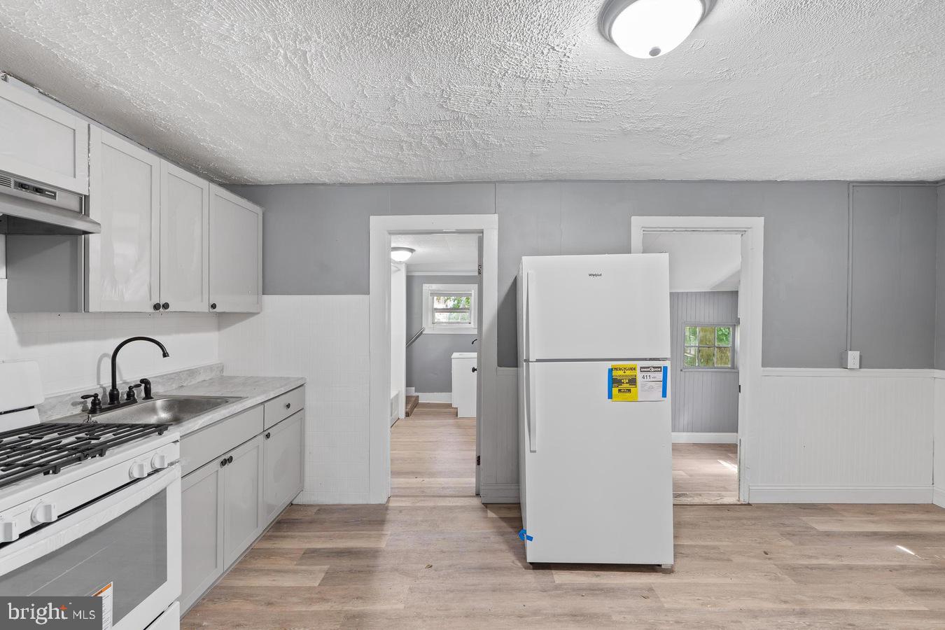 210 Church Street Salem, NJ 08079 - Photo 30 of 35 a kitchen with a sink a stove and refrigerator