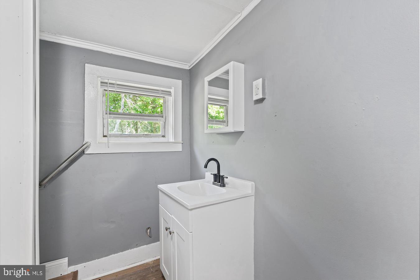 210 Church Street Salem, NJ 08079 - Photo 31 of 35 a bathroom with a sink a window and a mirror