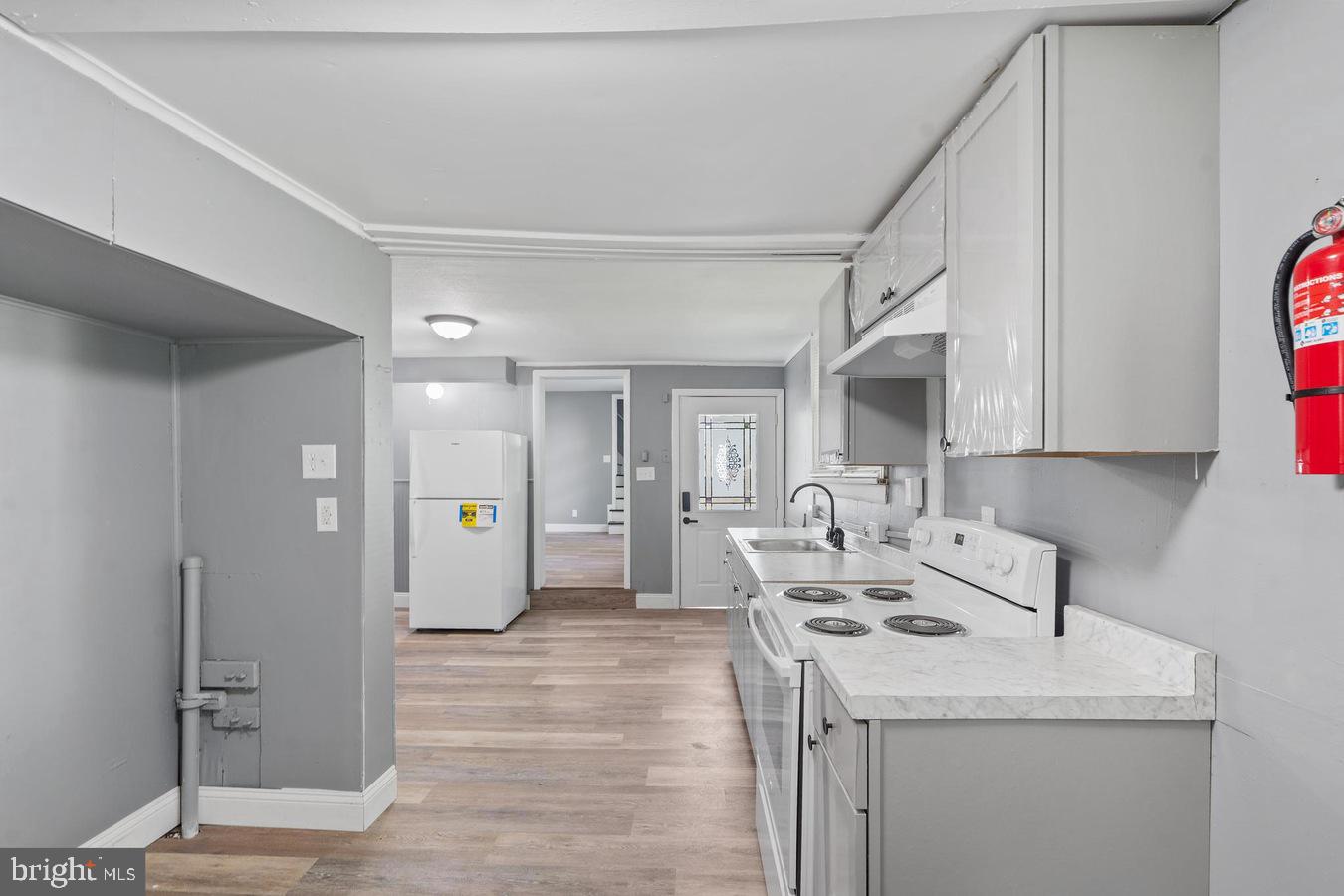 210 Church Street Salem, NJ 08079 - Photo 9 of 35 a kitchen with a sink a stove and refrigerator