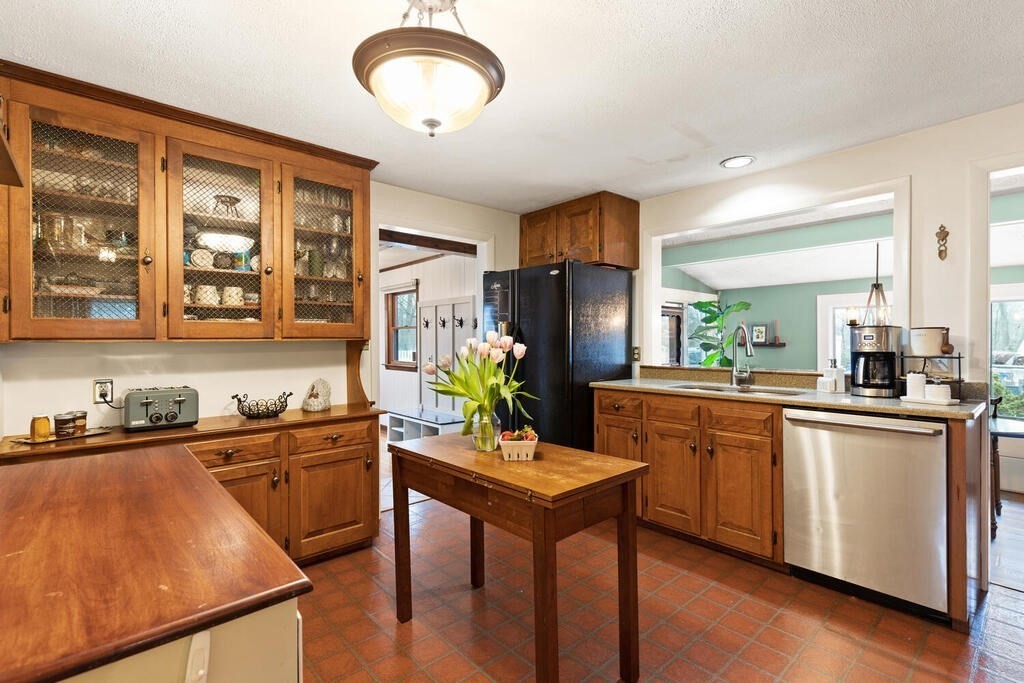 1 Meadowbrook Road Hudson, MA 01749 - Photo 16 of 36 a kitchen with stainless steel appliances granite countertop sink stove and wooden cabinets