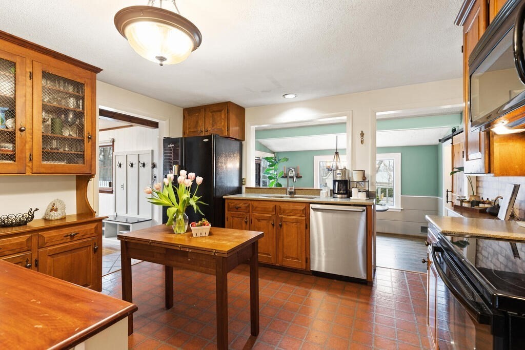 1 Meadowbrook Road Hudson, MA 01749 - Photo 17 of 36 a kitchen with sink a stove and chairs