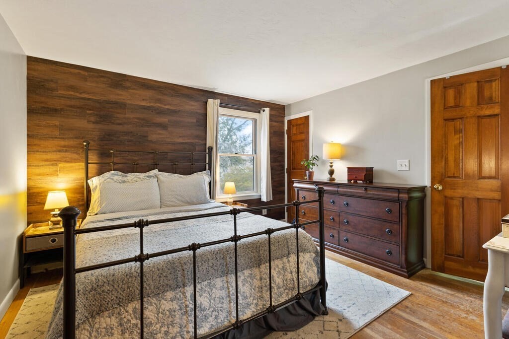 1 Meadowbrook Road Hudson, MA 01749 - Photo 23 of 36 a bedroom with a bed and wooden floor