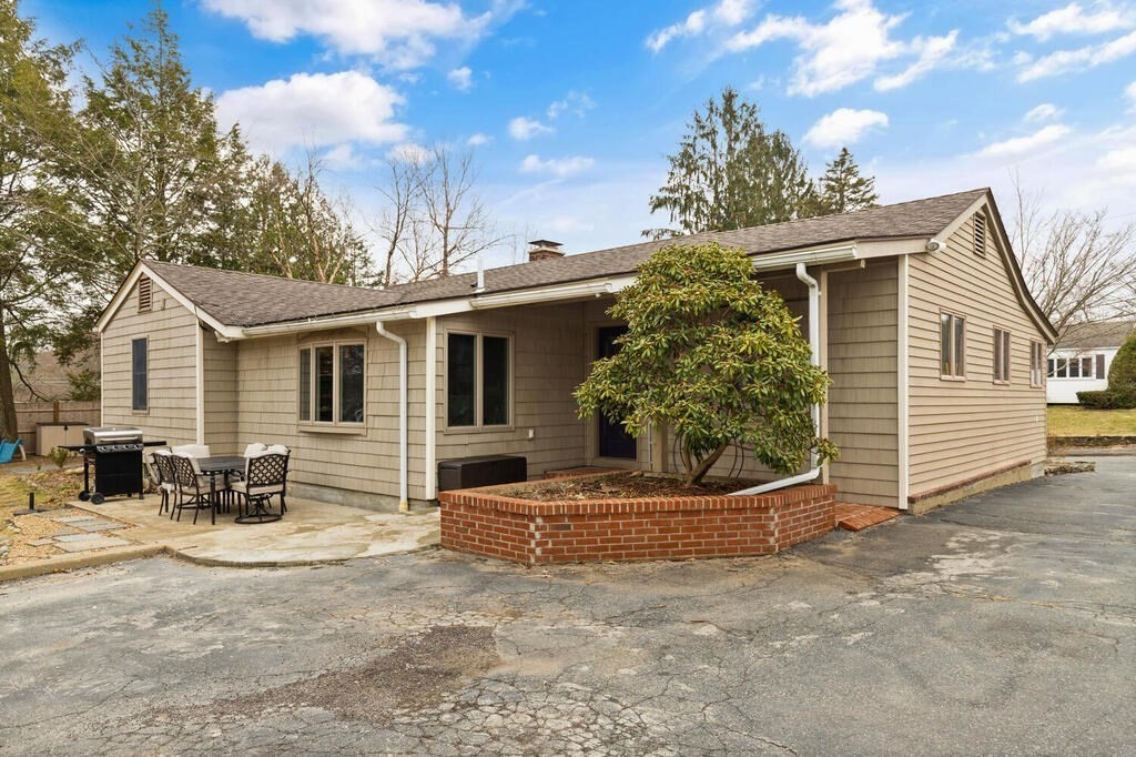 1 Meadowbrook Road Hudson, MA 01749 - Photo 27 of 36 a view of a house with a small yard and large tree