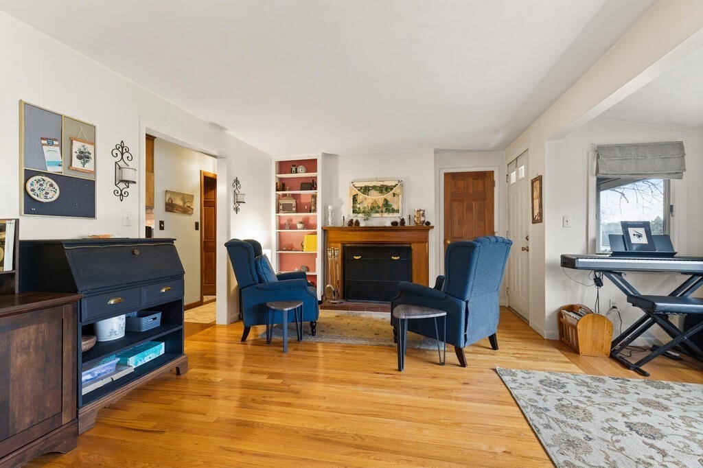 1 Meadowbrook Road Hudson, MA 01749 - Photo 8 of 36 a living room with furniture and a dining table with wooden floor