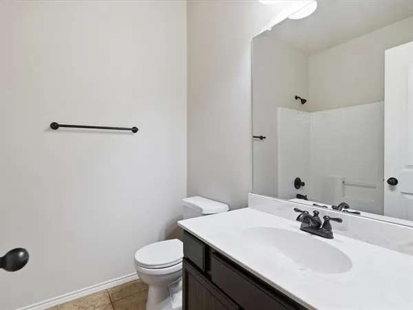 a bathroom with a sink toilet and a mirror