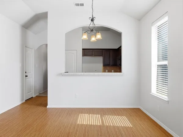 a view of a livingroom with wooden floor and a ceiling fan