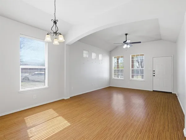 a view of livingroom with window chandelier fan and wooden floor