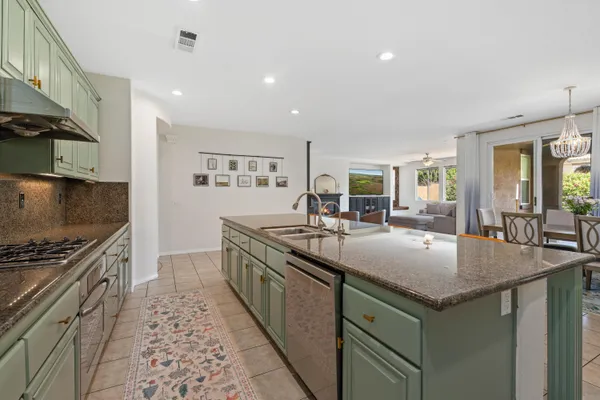 a kitchen with granite countertop a sink and stove