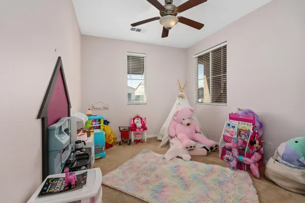 a bed room with a bed a window and a chandelier