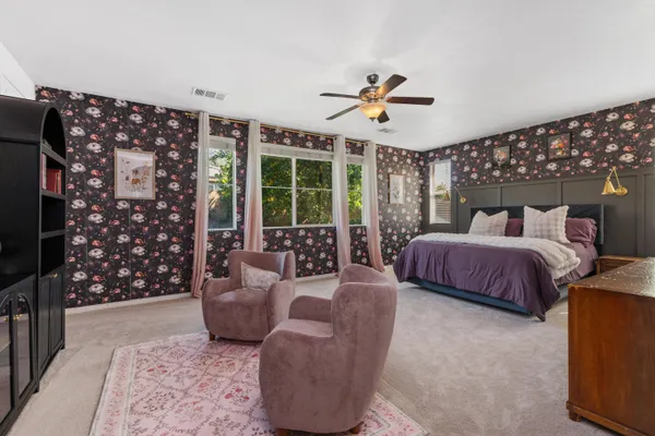 a bedroom with a large bed and a couch