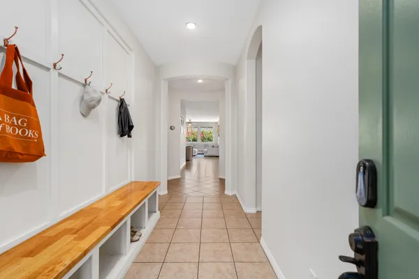 a hallway with a white cabinets and wooden floor