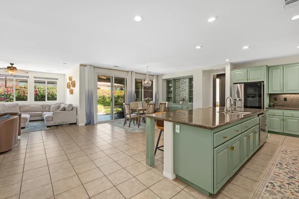 a kitchen with stainless steel appliances lots of counter top space and furniture