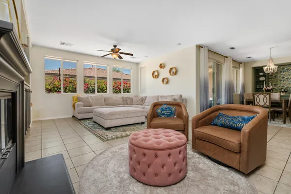 a living room with furniture ceiling fan and a rug