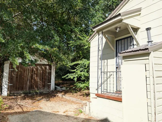 a view of a house with a door and wooden walls