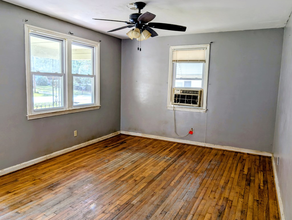 4237 Fort Street Columbus, GA 31907 - Photo 3 of 16 a view of an empty room with wooden floor and a window