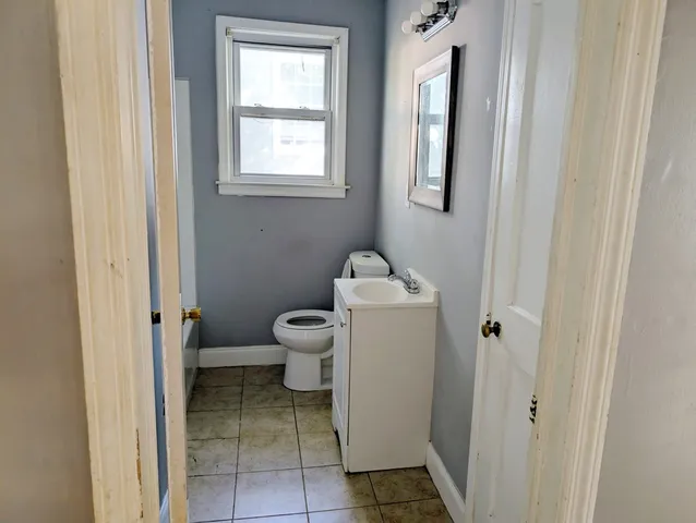 a bathroom with a toilet and a window