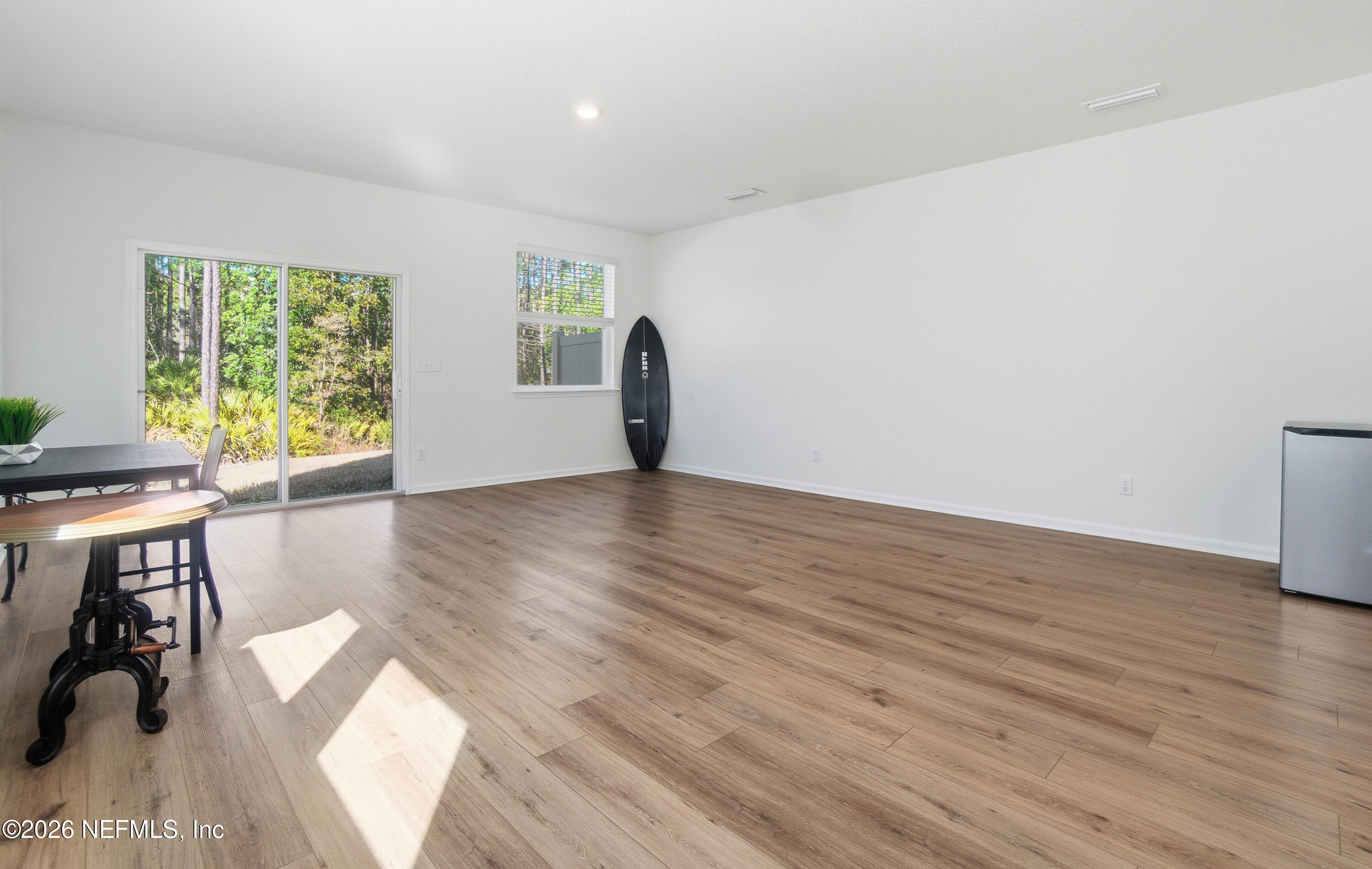 7662 Merchants Way Jacksonville, FL 32222 - Photo 11 of 32 a view of a big room with wooden floor and windows
