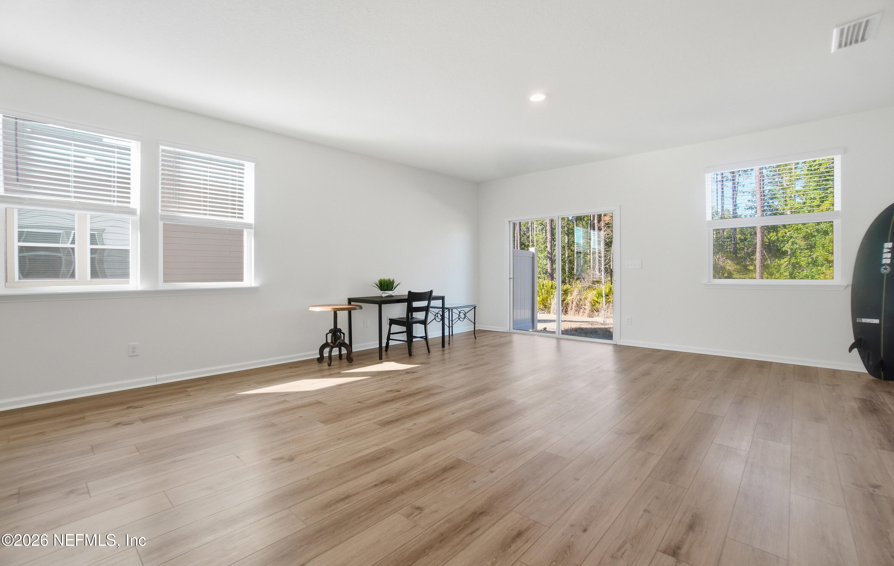 7662 Merchants Way Jacksonville, FL 32222 - Photo 12 of 32 a view of an empty room with wooden floor and a window