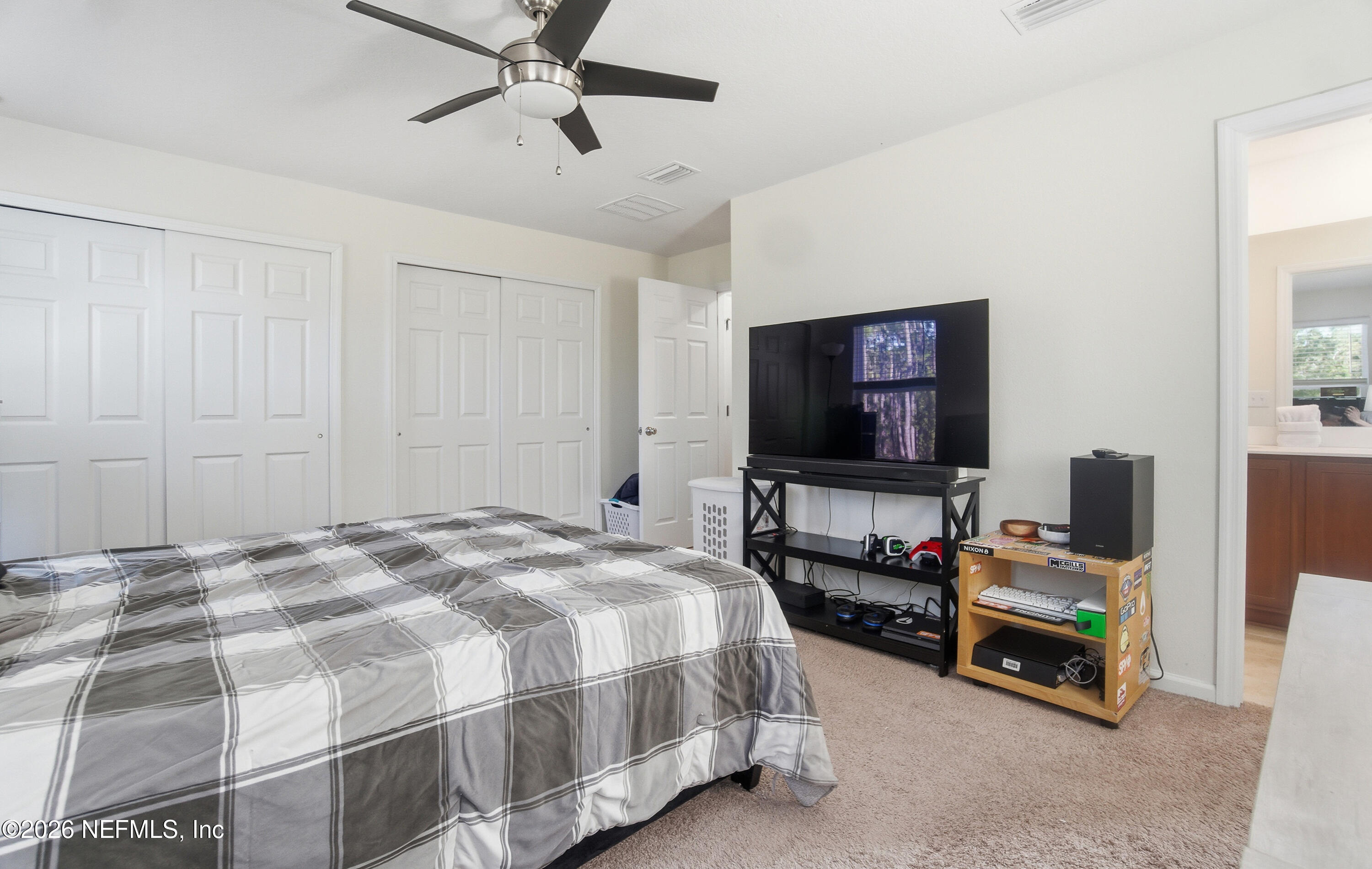 7662 Merchants Way Jacksonville, FL 32222 - Photo 15 of 32 a bedroom with a bed and a flat screen tv