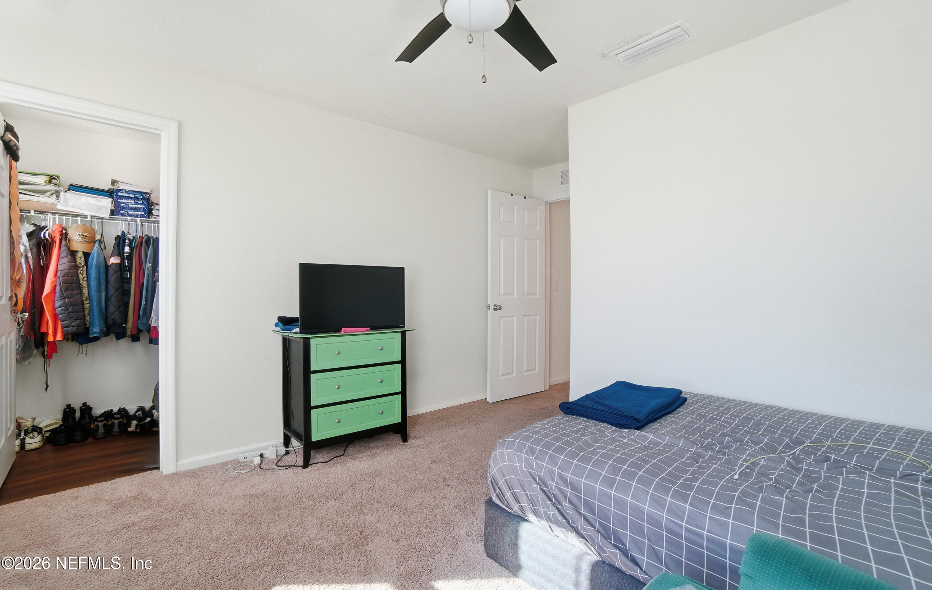 7662 Merchants Way Jacksonville, FL 32222 - Photo 21 of 32 a bedroom with a bed and a television